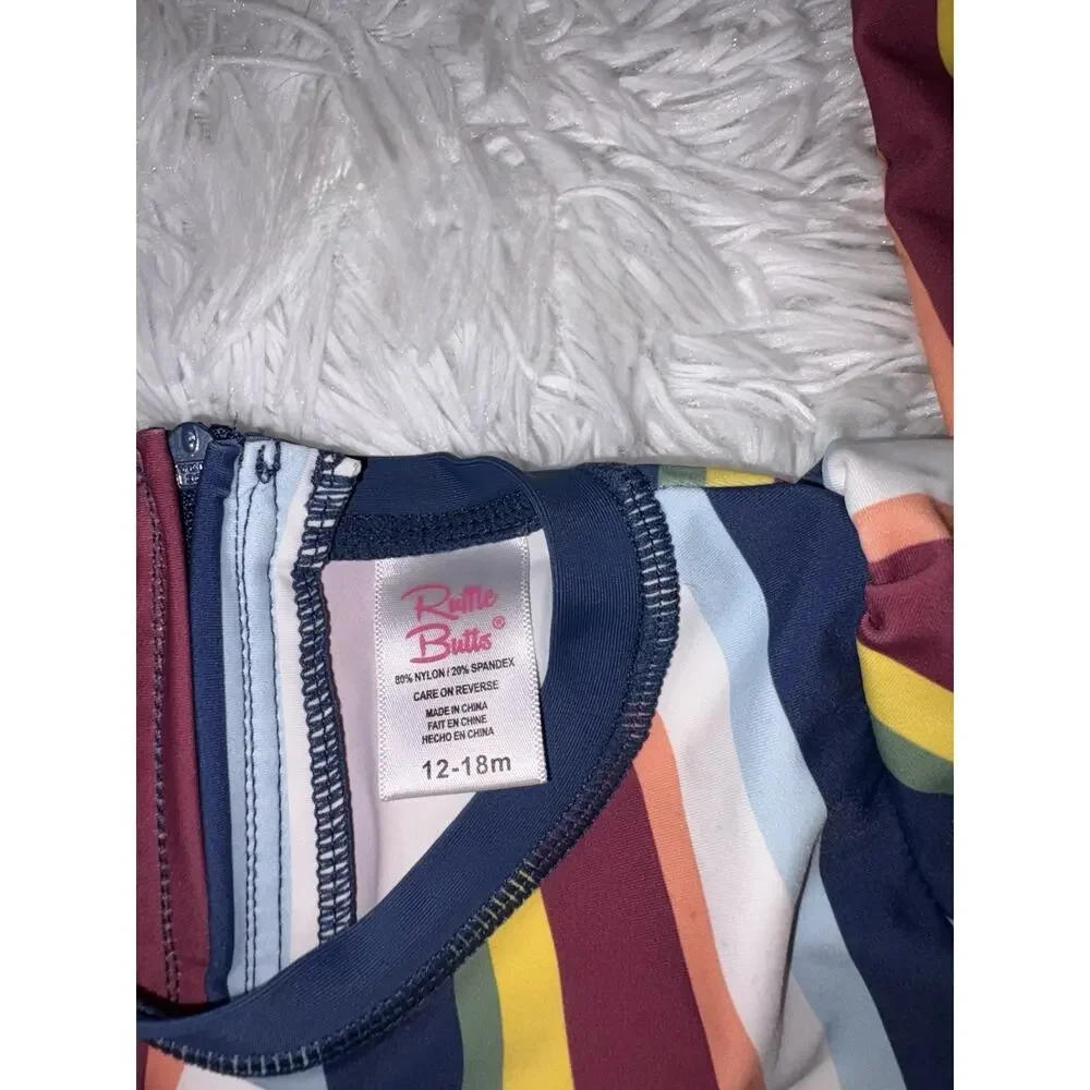 Ruffle Butts Girls 12/18 Mos. One Pc. “Sunset Stripes” Suit. Excellent Condition